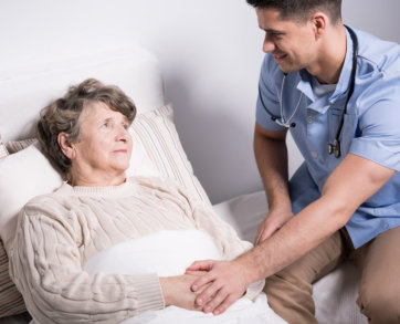 caregiver looking at the senior woman