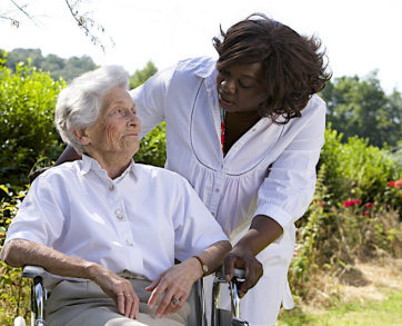 caregiver and senior woman looking at each other