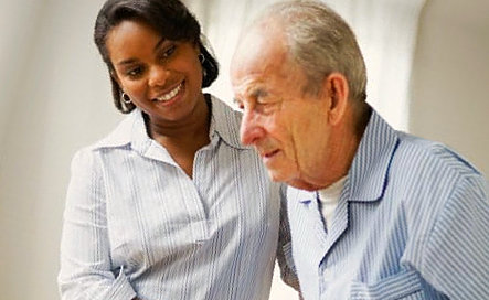 caregiver smiling at the senior man